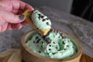 creamy mint chocolate chip dip recipe served on a cookie
