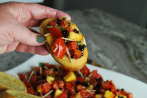 Easy Homemade Fresh Peach and Tomato Bruschetta served on garlic toast