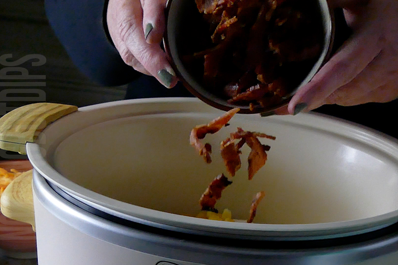 adding bacon pieces to the crockpot for cheesy corn and bacon
