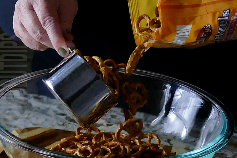 add 6 cups of mini pretzels to a large mixing bowl