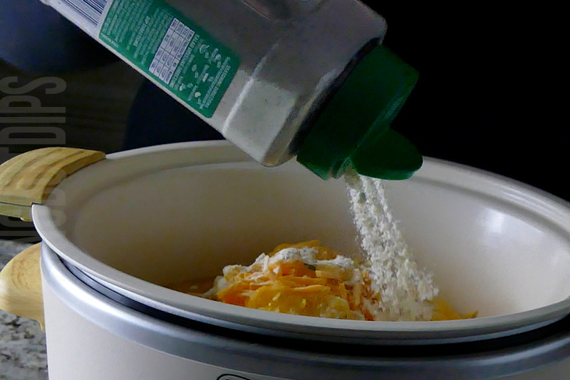 adding ranch powder to the crockpot for cheesy corn and bacon