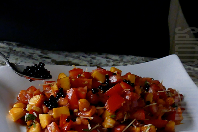 garnishing the peach and tomato bruschetta with balsamic pearls