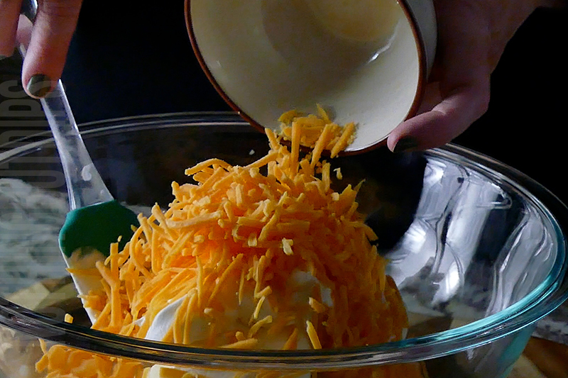 adding shredded cheddar cheese jalapeno popper cheese ball base