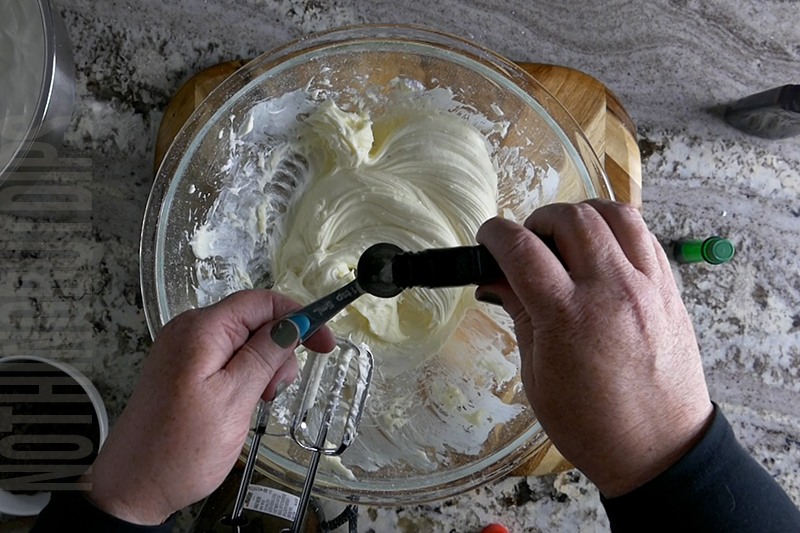 adding mint extract to the bowl to make mint chocolate chip dip