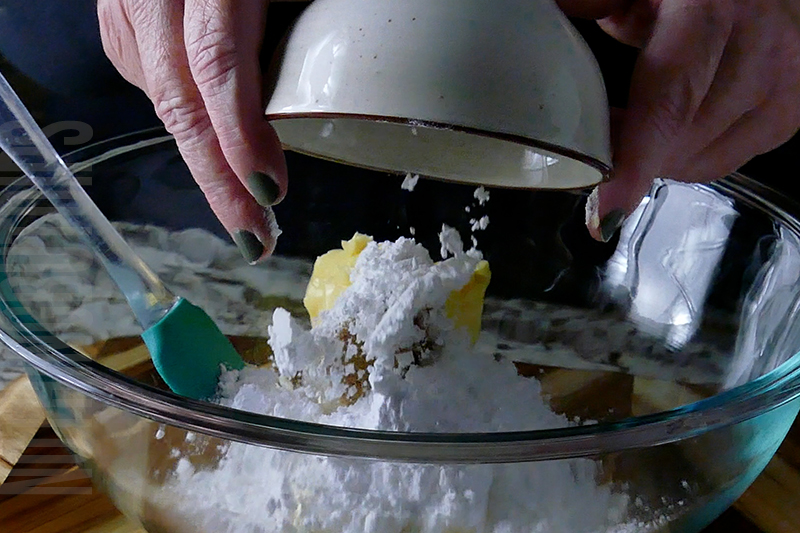 adding powdered sugar to the base of the strawberry pretzel salad dip
