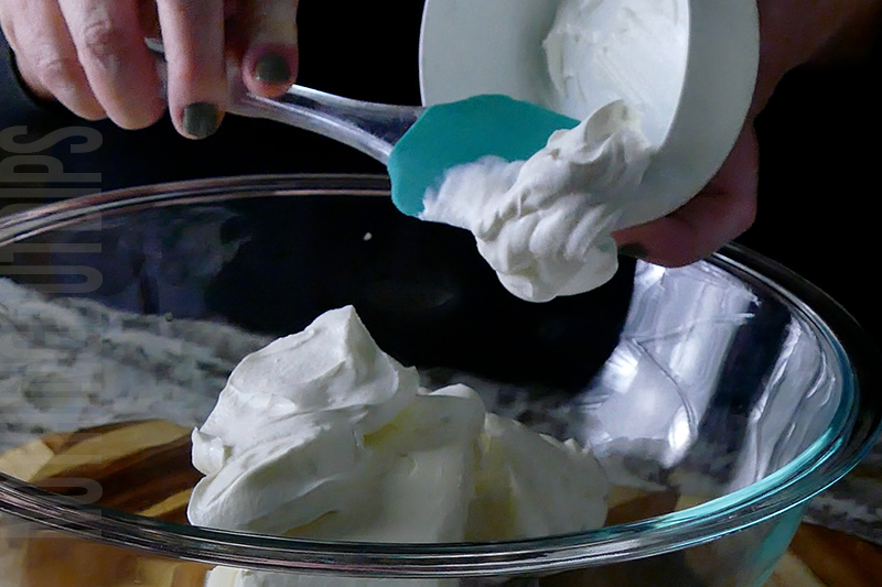 adding sour cream to the jalapeno popper cheese ball base