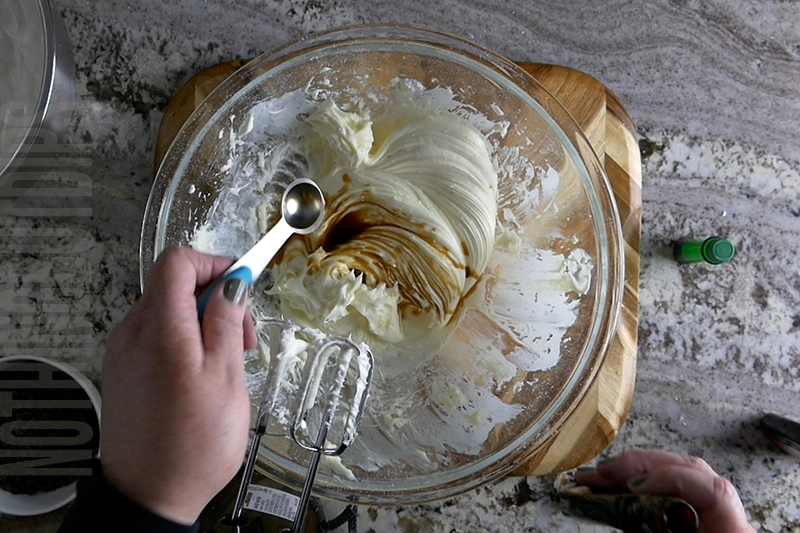 adding vanilla to the bowl to make mint chocolate chip dip