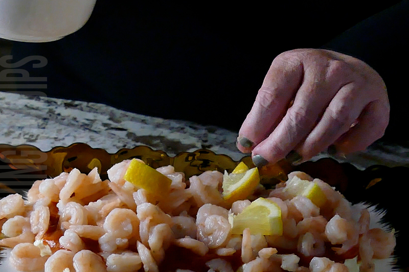 Garnishing the shrimp cocktail dip with small wedges of lemon