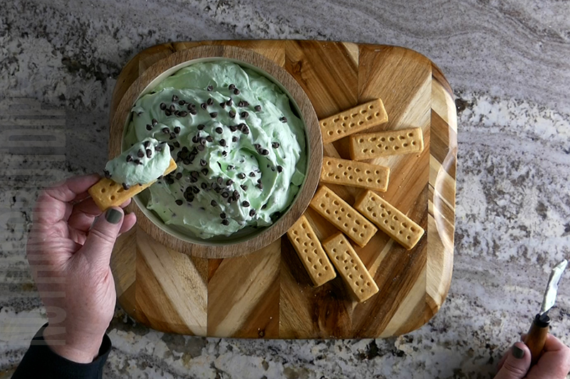 creamy mint chocolate chip dip recipe served on a cookie
