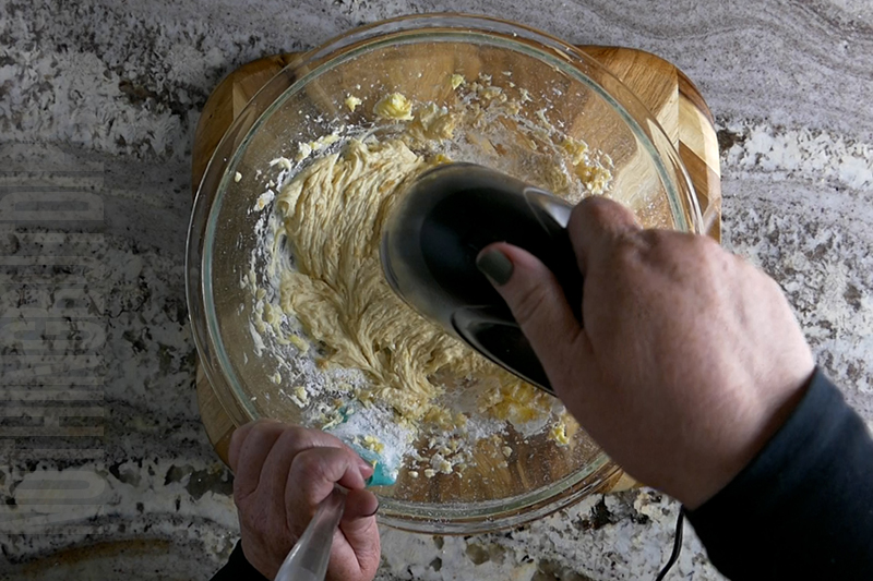 mixing the cream for the strawberry pretzel salad dip