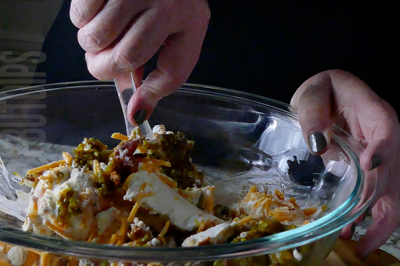 mixing the ingredients for jalapeno popper cheese ball