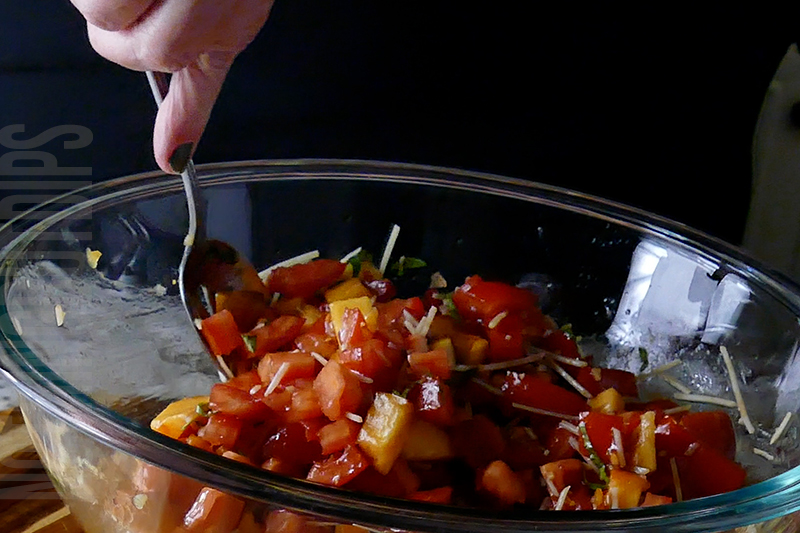 mixing the ingredients for peach and tomato bruschetta