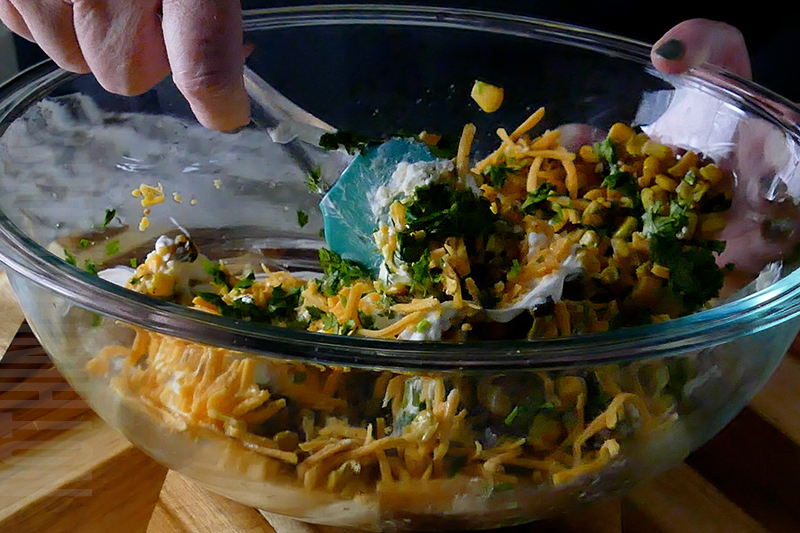 mixing together the ingredients for Mexican street corn dip