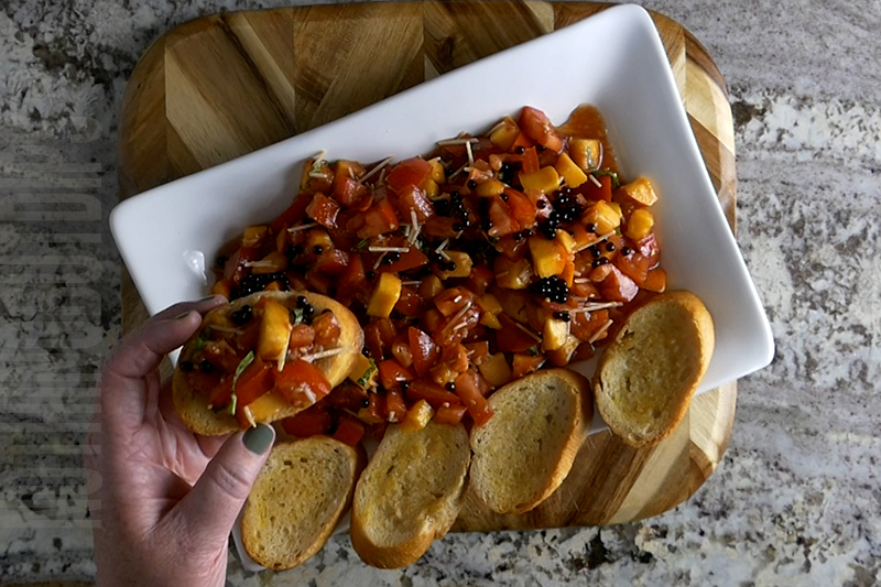 Easy Homemade Fresh Peach and Tomato Bruschetta served on garlic toast