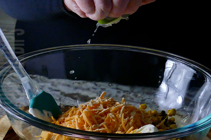 adding lime to the Mexican corn dip