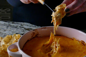 Baked buffalo chicken dip served on tortilla chips