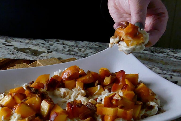 Easy Burrata with peaches appetizer served on a cracker