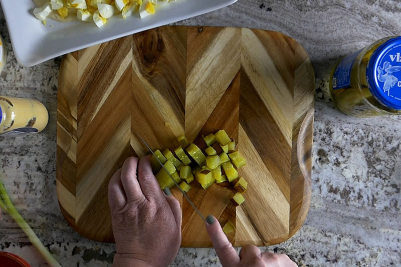 chopping the dill pickles
