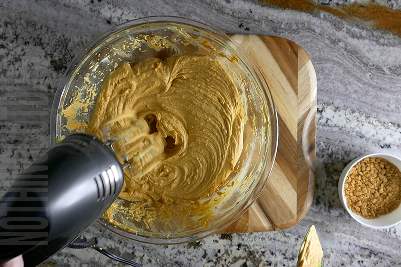 mixing together the ingredients for pumpkin cheesecake dip